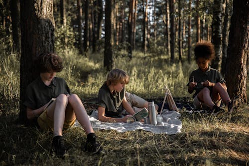 Free Campers Sitting on Grass Field Stock Photo
