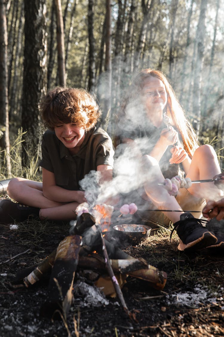 Campers Heating Food On The Bonfire