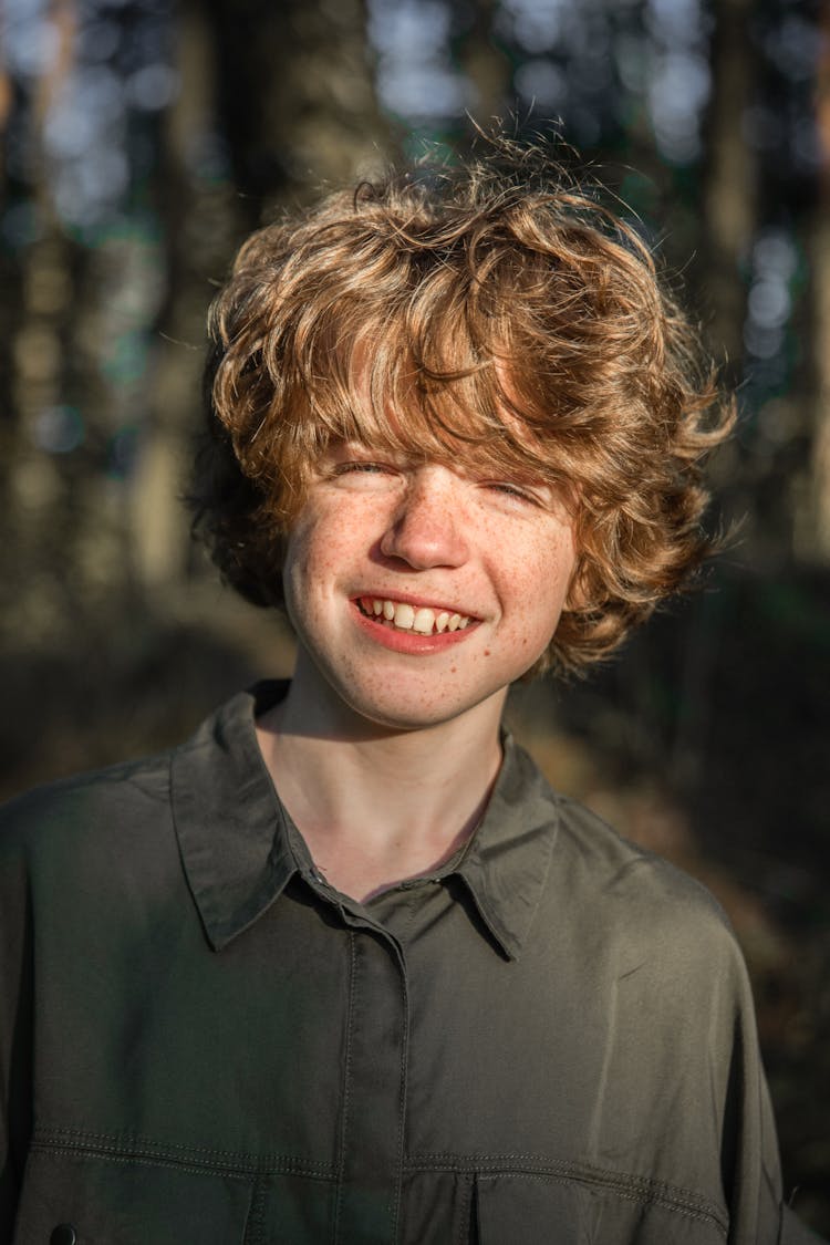 Boy In Khaki Shirt Smiling