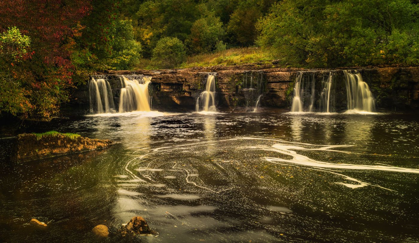 Autumn waterfall and pond