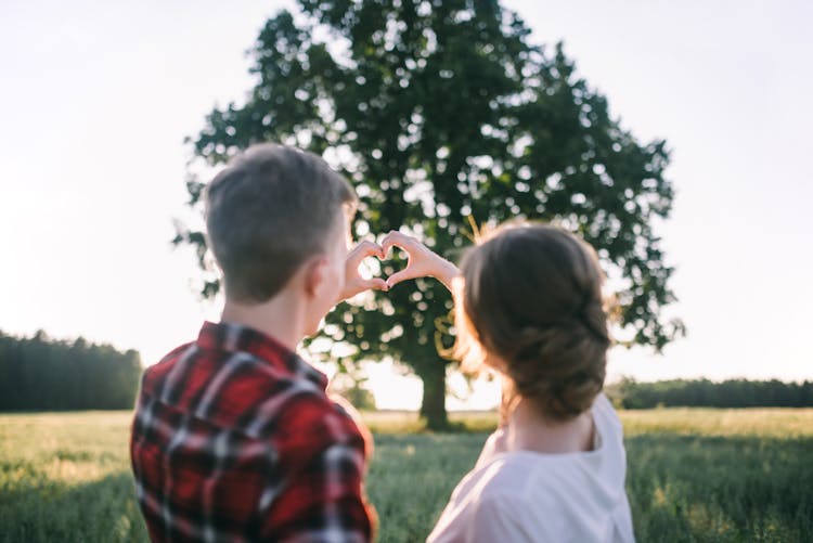 Man And Woman Making A Heart With Hand