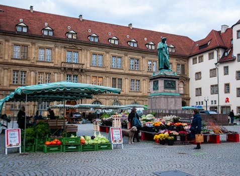 Explore the bustling street market in Stuttgart with colorful produce and historical architecture.