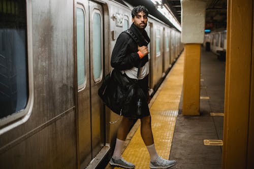 Man in Sports Clothing Getting off the Subway Train 