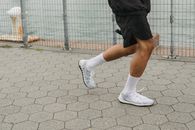 Person in Black Shorts and White Nike Sneakers