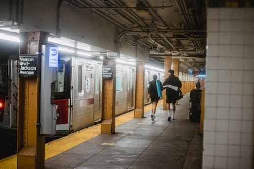 Man and Woman Walking on Subway Platform