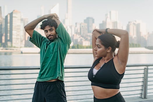 Two adults stretching by a city waterfront, promoting a healthy lifestyle.