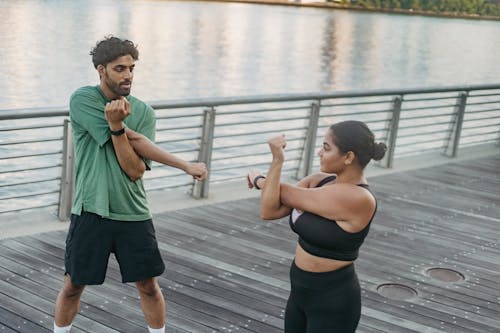 Free Man and Woman Looking at Each Other While Exercising Stock Photo