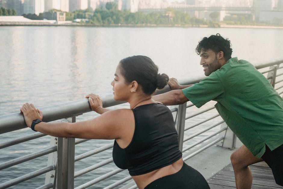 Man and Woman Wearing Activewear Leaning on a Railing