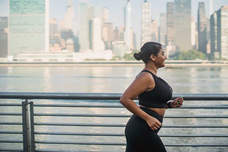 Woman Running Beside A River