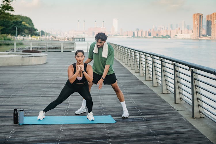 Friends Doing Exercise On The Boardwalk