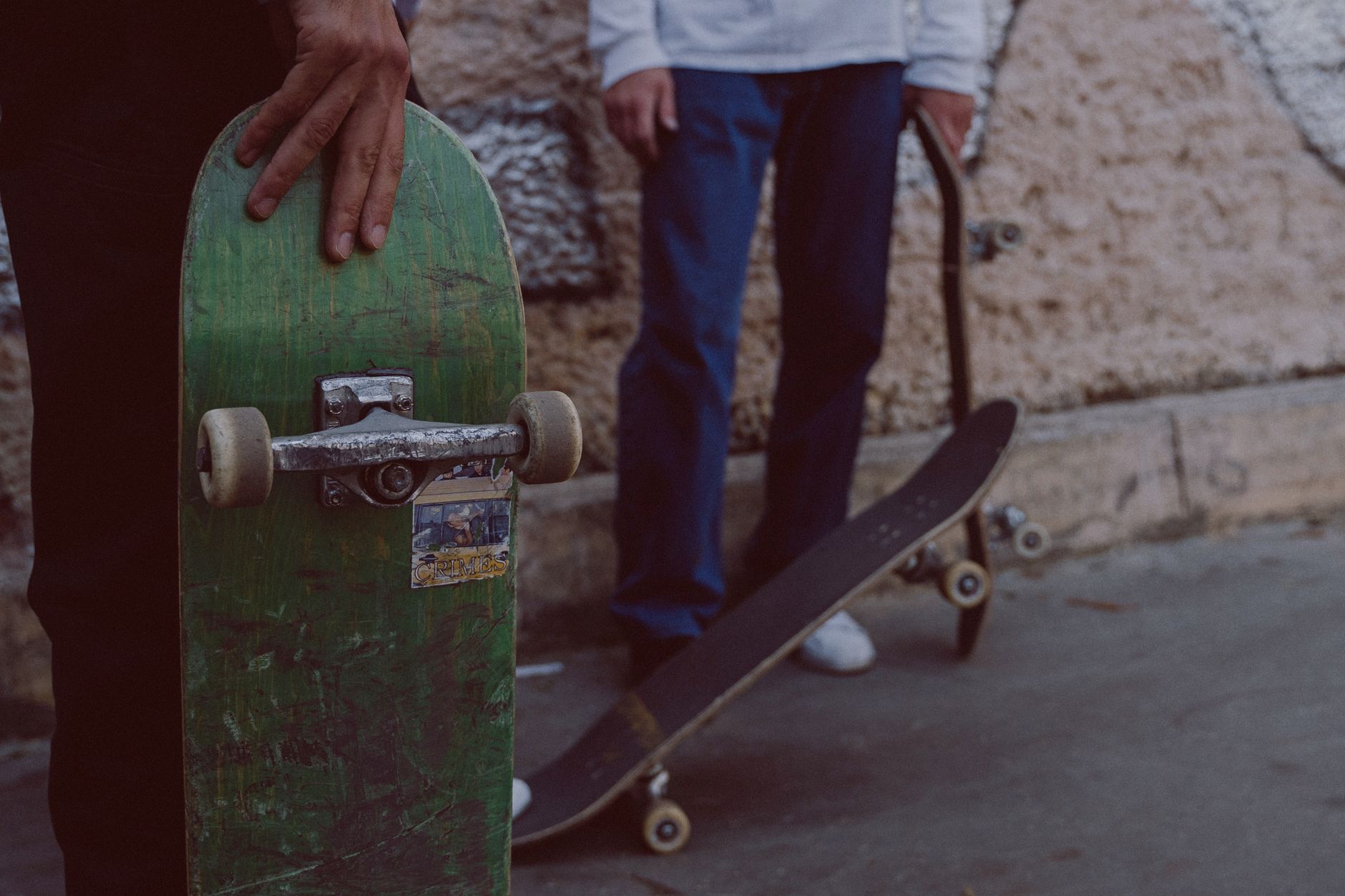 Close-up of an old skateboard blog printout beside worn wheels and a punk rock cassette