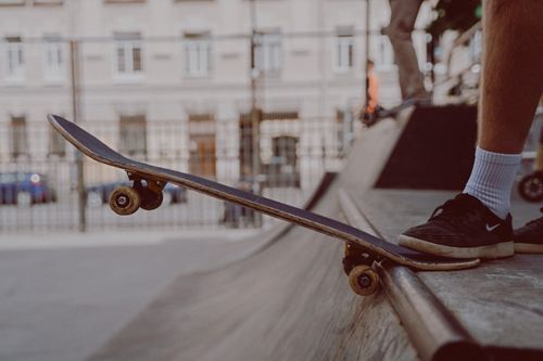 Free Close-up of skateboarder poised to perform a trick at an outdoor skatepark. Stock Photo