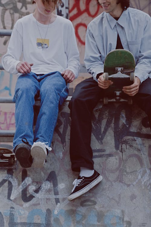 Free Men with Skateboards Sitting on a Ramp Stock Photo