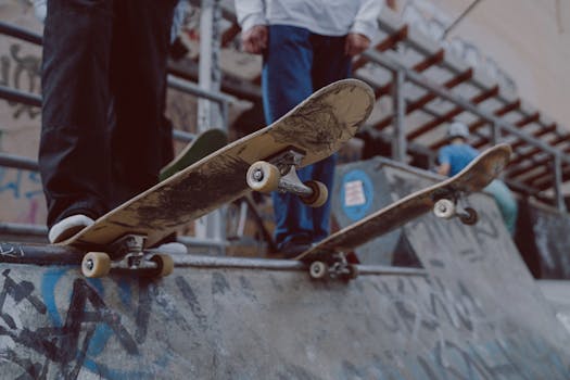 Teenagers skateboarding on a graffiti-covered ramp, showcasing urban culture.