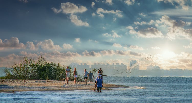 People Standing On The Beach Shore