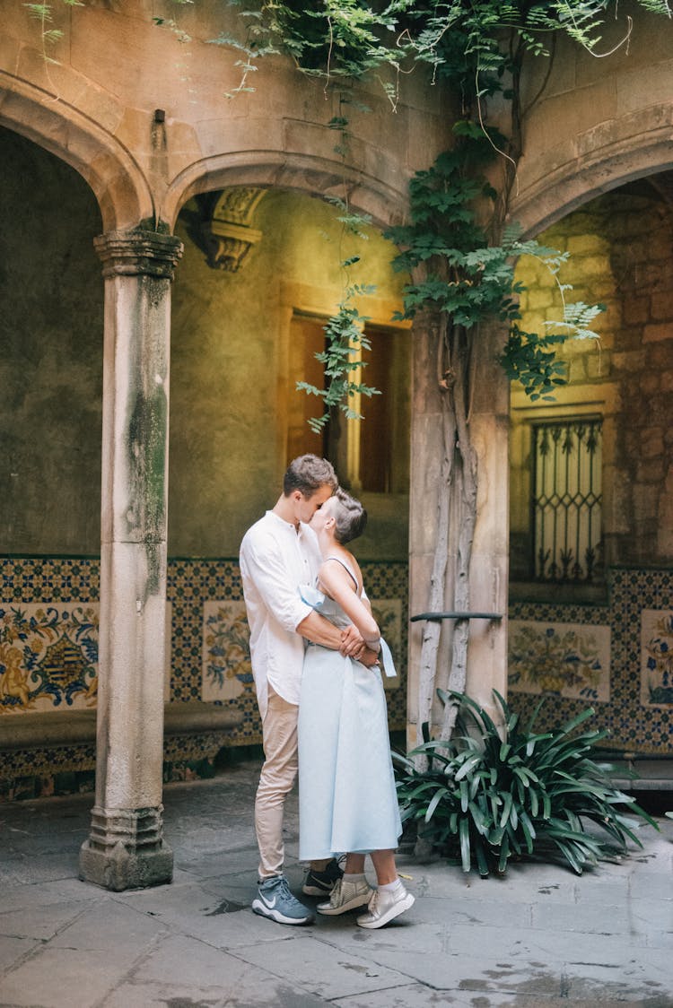 Man And Woman Kissing Outside An Old Building 