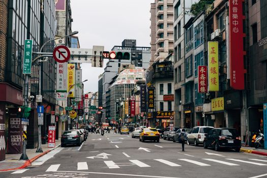 Vibrant city scene featuring busy street, skyscrapers, and colorful signage in an Asian urban area.