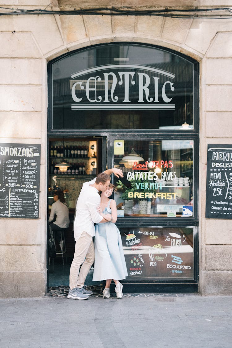 A Couple Standing On The Street Together