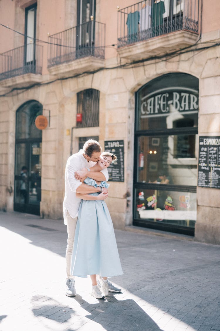 A Couple Embracing On The Street