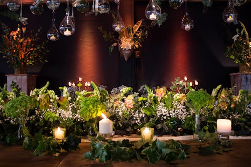 Flower Arrangement and Lit Candles 