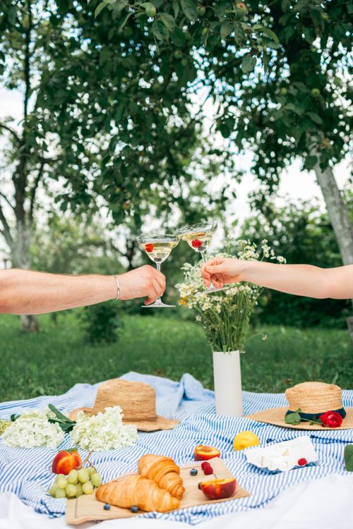 Person Holding White and Red Flower Bouquet