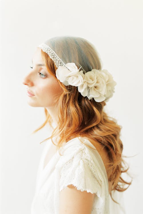 Woman Wearing a Wedding Dress and a Headpiece 