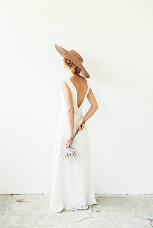  A Woman in White Dress Wearing Sun Hat