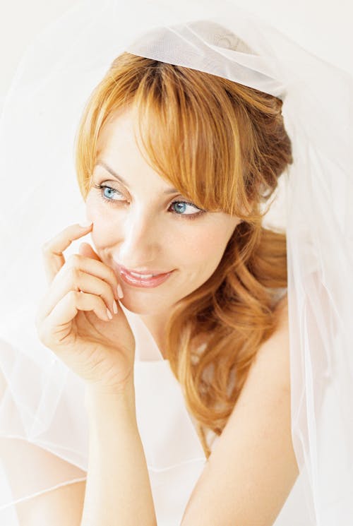 Close Up Photo of Woman in White Dress Smiling