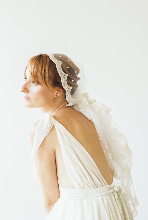 Woman in White Sleeveless and Sexy Back Dress Wearing White Veil