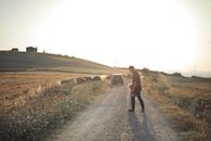 Man and Woman Walking on Road