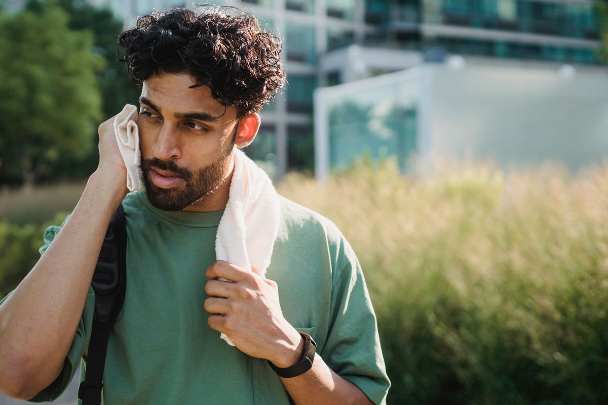 Man relaxing with towel after exercising outdoors