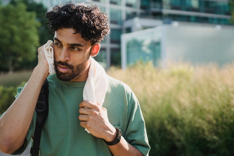 Man Relaxing With Towel After Exercising 