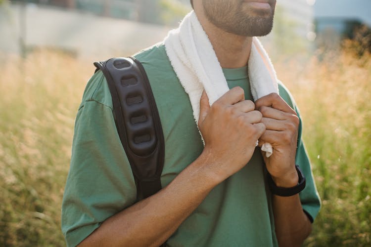 Man Holding A Towel Around His Neck