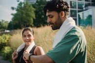 Man in Green Shirt Beside Woman in White Shirt