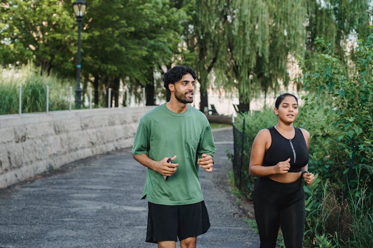 Woman And Man Jogging In Park