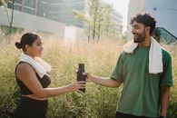 Man in Green Polo Shirt Holding Black Smartphone