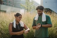 Man in Green Tank Top Beside Woman in White Tank Top