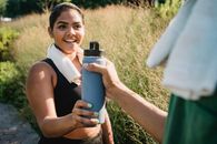 Woman in Black Tank Top Holding Blue and Black Thermal Carafe