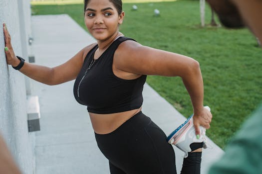 Athletic woman stretching her leg during outdoor exercise, promoting active lifestyle.