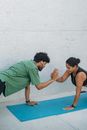Man in Green T-shirt and Black Shorts Doing Push Up