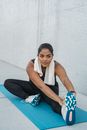 Woman in White Tank Top and Black Leggings Sitting on Blue Yoga Mat