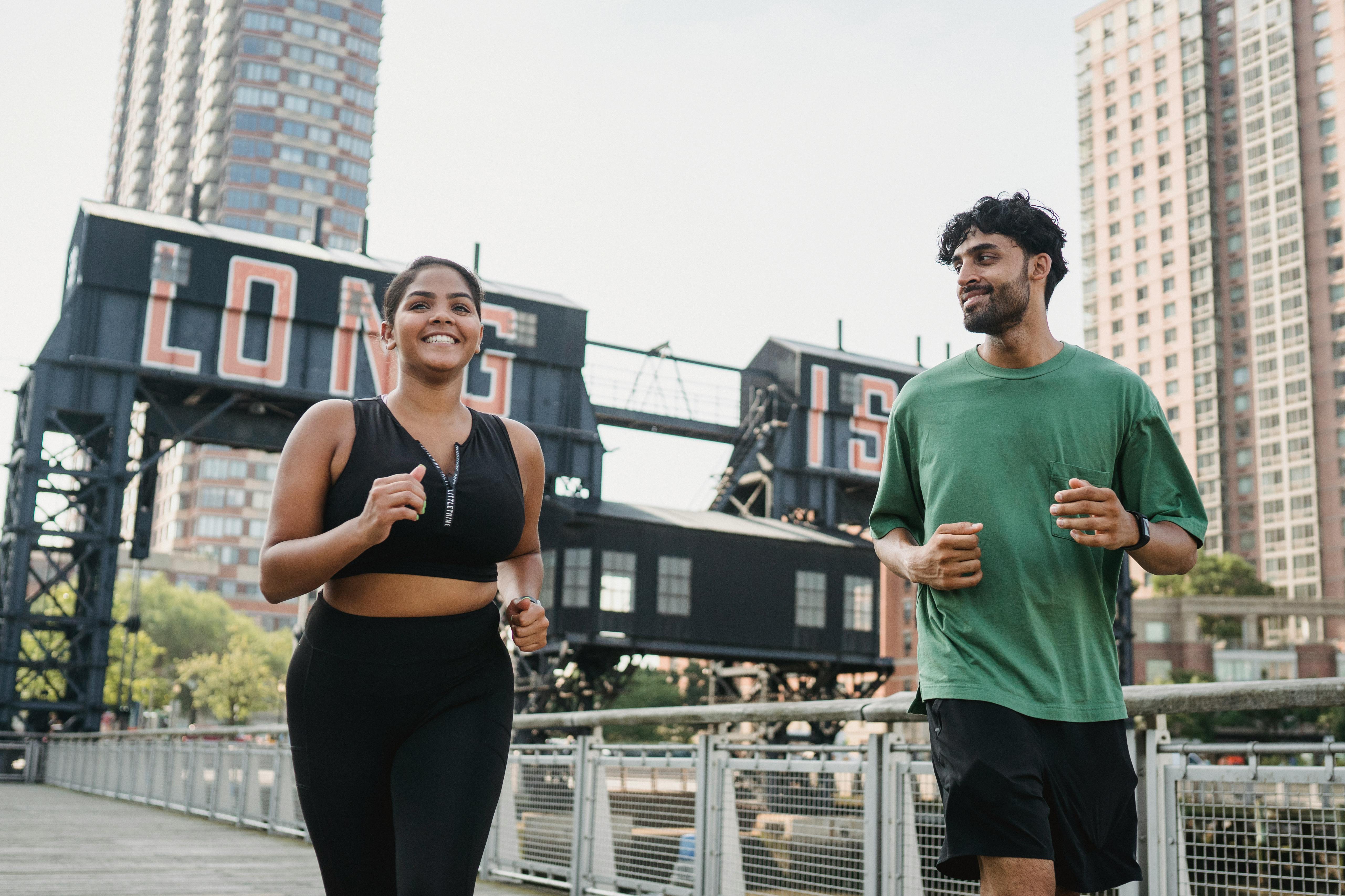 A man and woman jogging in Long Island City, showcasing urban fitness lifestyle.