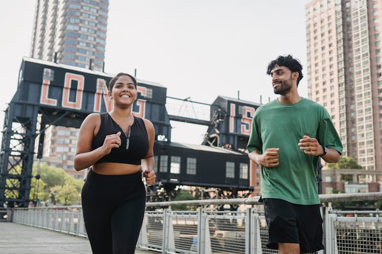 Man And Woman Jogging In City 