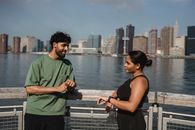 Man and Woman Standing Beside Railings Near Body of Water