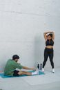 Woman in Black Sports Bra and Black Leggings Doing Yoga