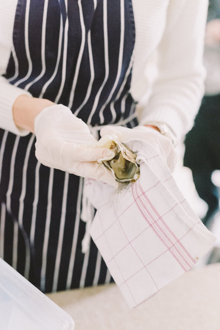 Woman In Kitchen Gloves Wiping Something With Towel 