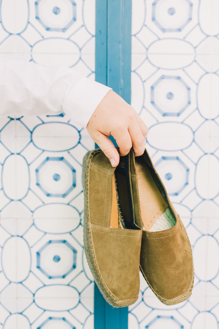 Person Hand Holding Espadrille Shoes