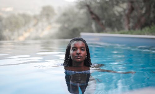 Portrait of Beautiful Woman Swimming in Pool