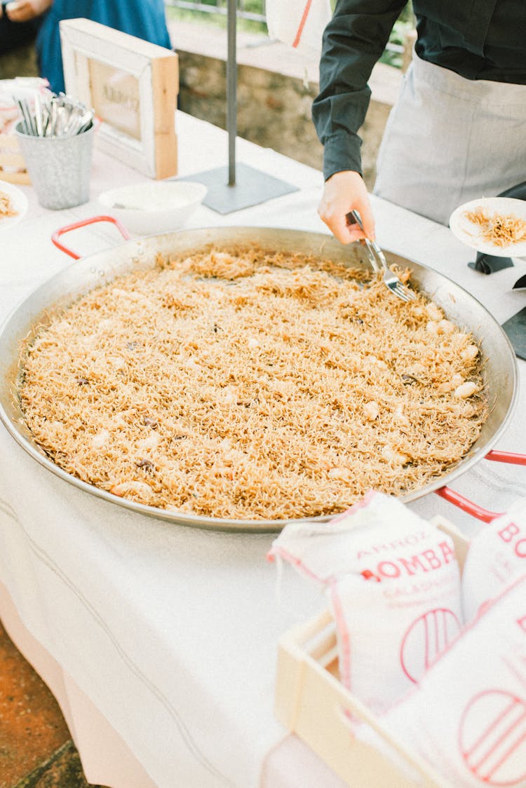 A Large Stainless Wok With Food