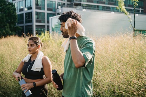 A Man and Woman Walking while Having Conversation